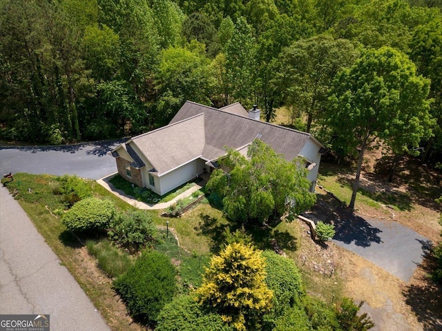 bird's eye view with a wooded view