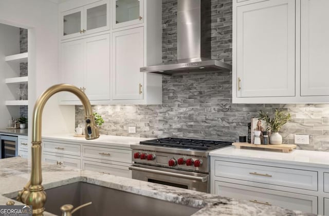 210 Marjean Way, Alpharetta, GA 30009 - kitchen featuring wall chimney exhaust hood, high end stove, wine cooler, white cabinetry, and backsplash