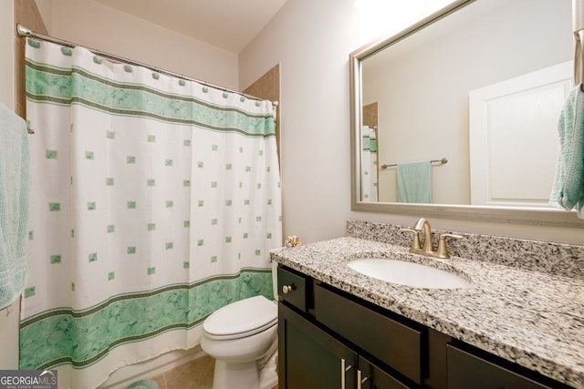 bathroom with toilet, vanity, and curtained shower
