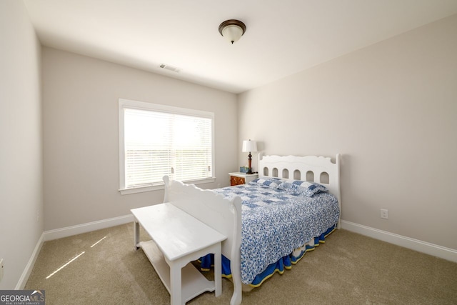 bedroom featuring carpet and baseboards
