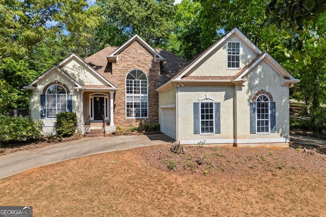 115 Stonewall Dr, Covington, GA 30016 - craftsman house featuring driveway, a garage, and stucco siding