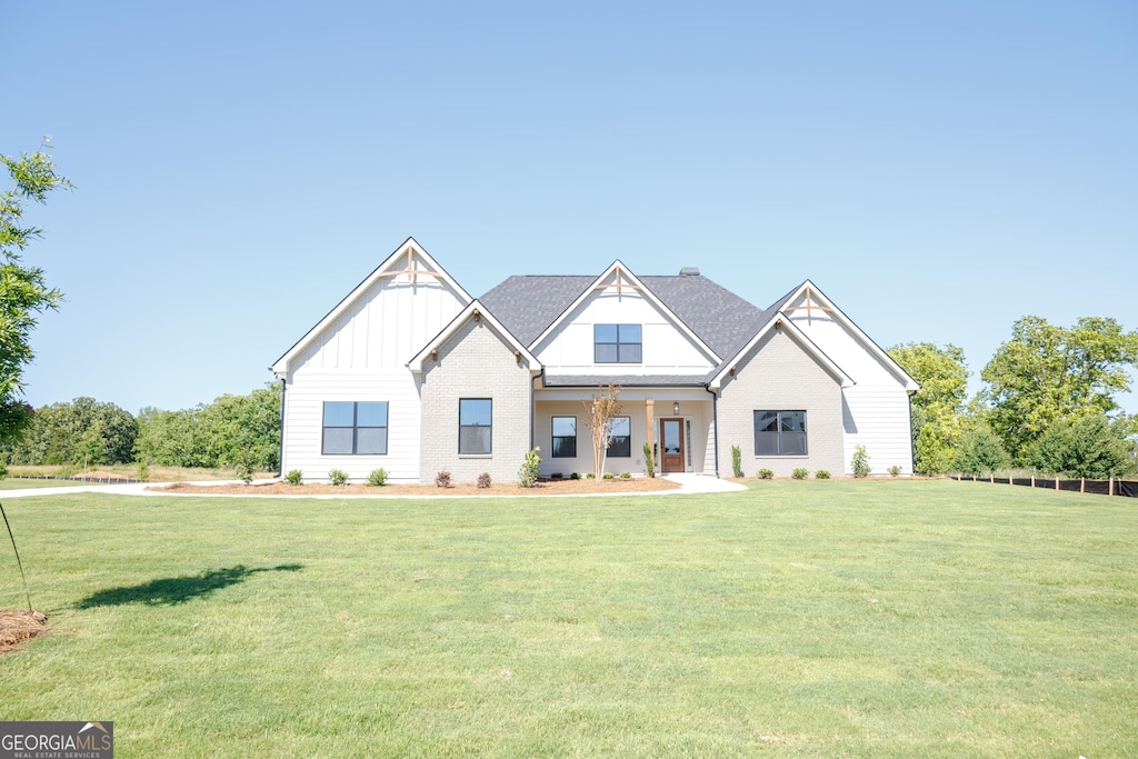 347 Grove Park Unit 86, Senoia, GA 30276 - view of front of house featuring board and batten siding and a front yard