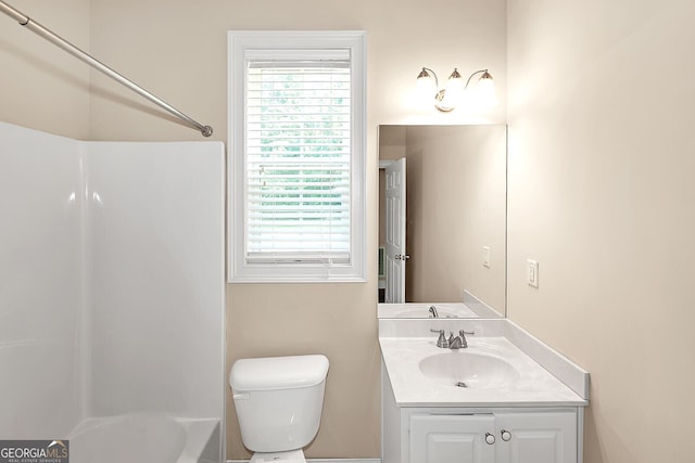 full bath with shower / bath combination, vanity, toilet, and a wealth of natural light