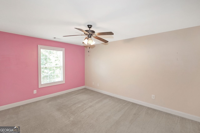 empty room with light carpet, baseboards, and a ceiling fan