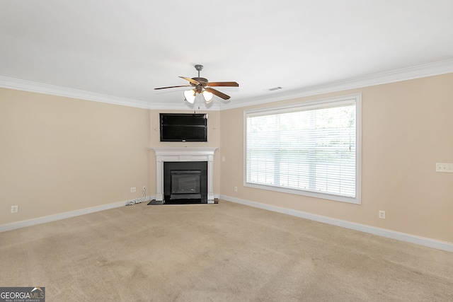 unfurnished living room featuring a ceiling fan, a fireplace with flush hearth, baseboards, light colored carpet, and ornamental molding
