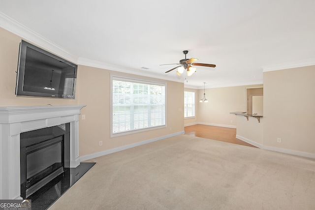 unfurnished living room with a ceiling fan, light carpet, ornamental molding, and a fireplace