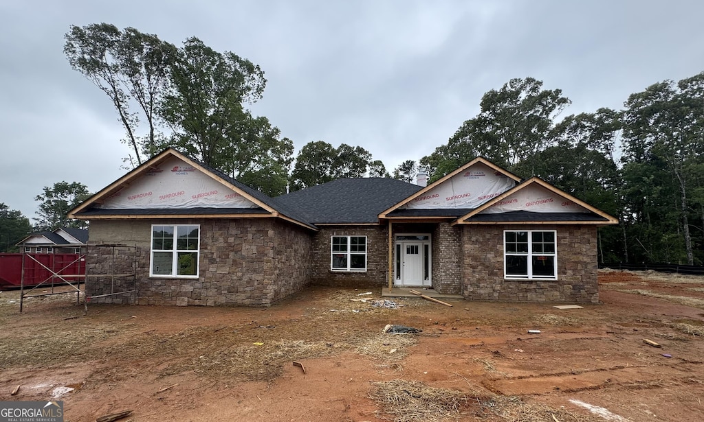 5351 Tuscany Dr, Douglasville, GA 30135 - unfinished property featuring stone siding and fence