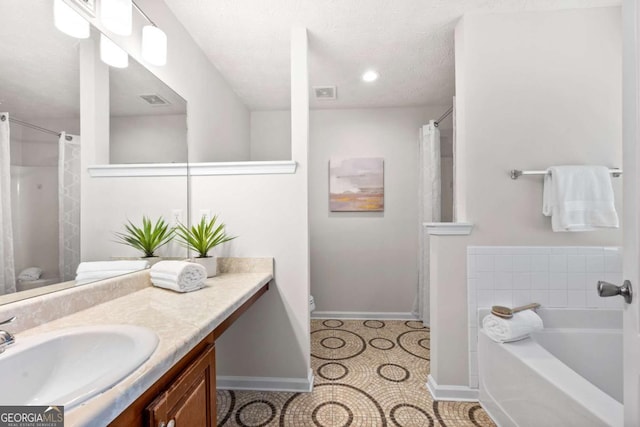 full bathroom with baseboards, toilet, visible vents, a bath, and vanity
