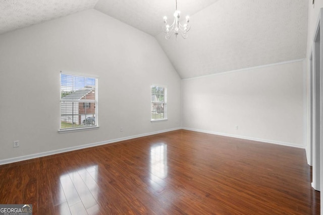additional living space featuring lofted ceiling, baseboards, a chandelier, and wood finished floors