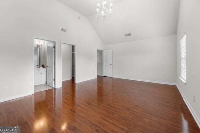 unfurnished bedroom with an inviting chandelier, high vaulted ceiling, visible vents, and multiple windows