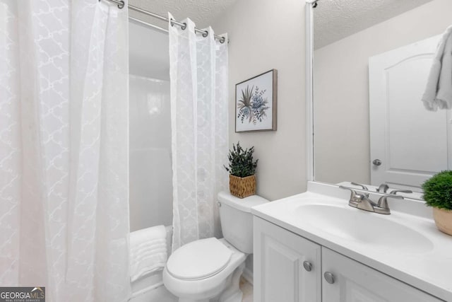 full bathroom with vanity, a textured ceiling, and toilet