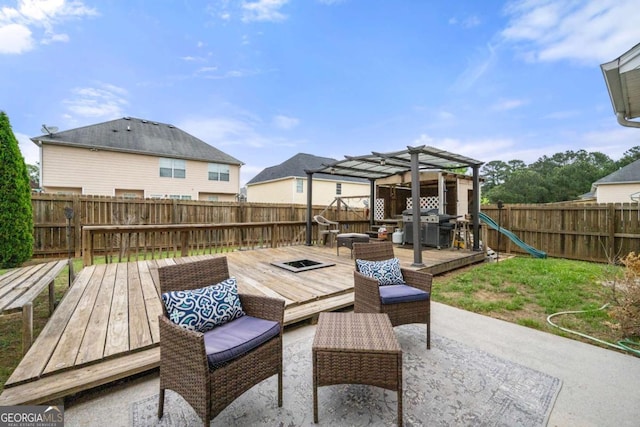 view of patio / terrace with a pergola, a wooden deck, a fenced backyard, and grilling area