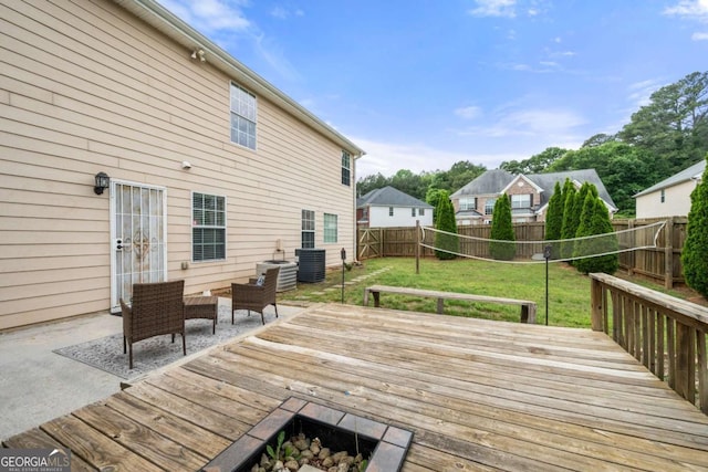 wooden deck featuring a yard, a fenced backyard, and central AC