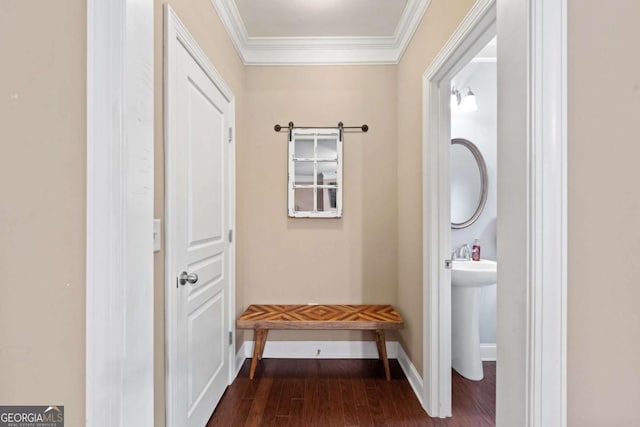 mudroom featuring crown molding, wood finished floors, and baseboards