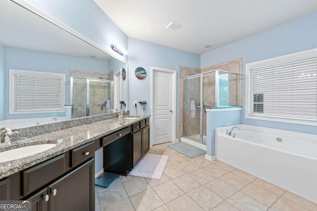 bathroom with a shower stall, a garden tub, visible vents, and a sink