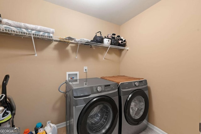 laundry room featuring laundry area, independent washer and dryer, and baseboards