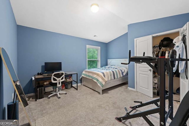 carpeted bedroom with a closet, vaulted ceiling, baseboards, and visible vents