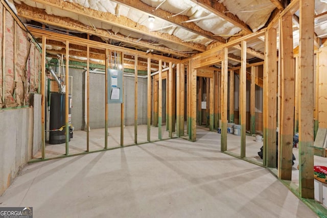 unfinished basement featuring water heater and electric panel