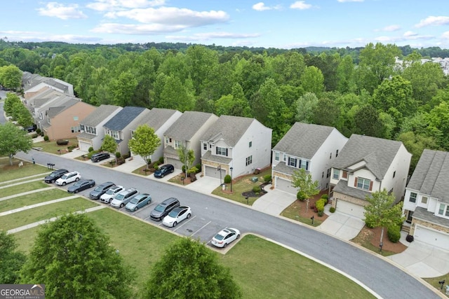 birds eye view of property featuring a residential view and a view of trees
