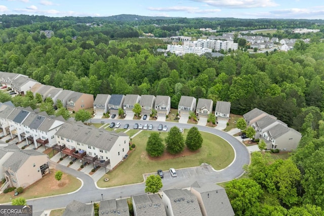 aerial view with a wooded view and a residential view