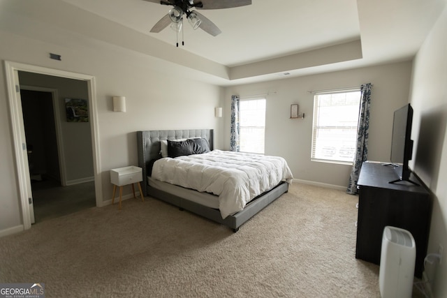 8045 Coleson Xing, Locust Grove, GA 30248 - carpeted bedroom with a raised ceiling, baseboards, and ceiling fan