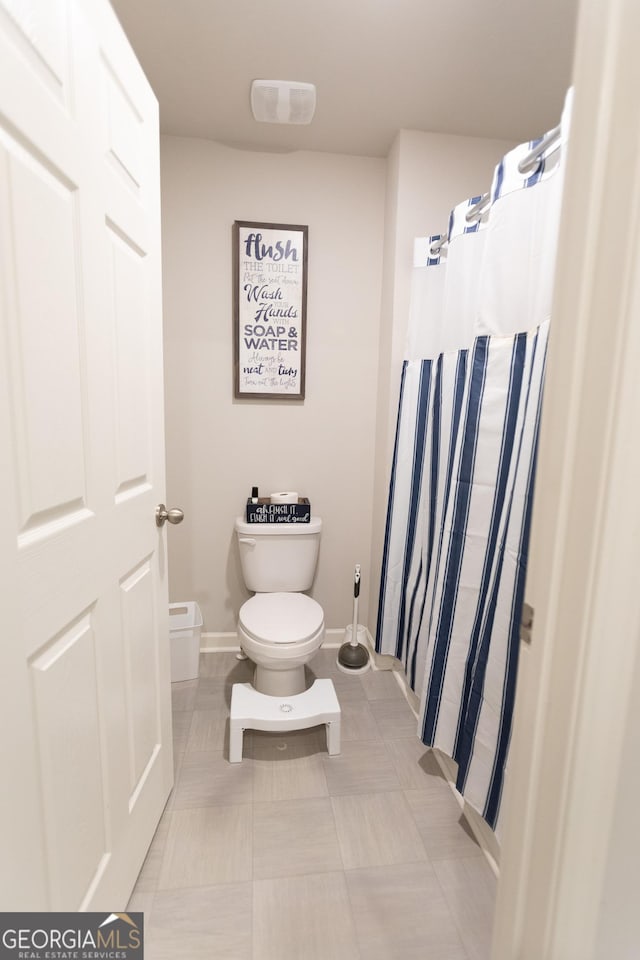 8045 Coleson Xing, Locust Grove, GA 30248 - full bath with toilet, baseboards, and curtained shower