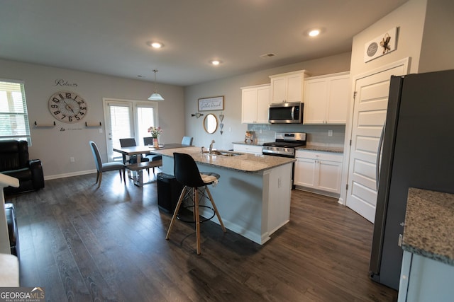 8045 Coleson Xing, Locust Grove, GA 30248 - kitchen with appliances with stainless steel finishes, a sink, white cabinets, decorative backsplash, and dark wood-style floors
