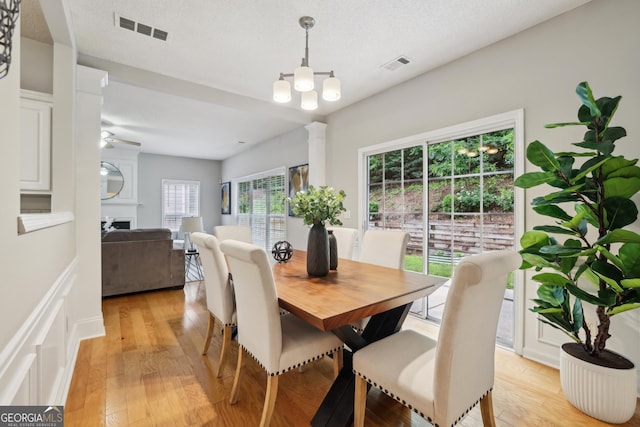 715 Alstonefield Dr, Alpharetta, GA 30004 - dining room with light wood-style floors, a fireplace, and a chandelier