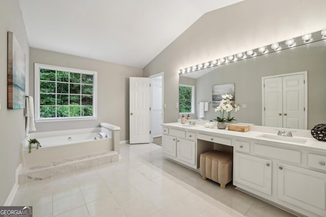 715 Alstonefield Dr, Alpharetta, GA 30004 - full bath featuring double vanity, lofted ceiling, a garden tub, baseboards, and tile patterned flooring