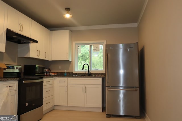 kitchen featuring a sink, dark stone countertops, stainless steel appliances, white cabinetry, and under cabinet range hood