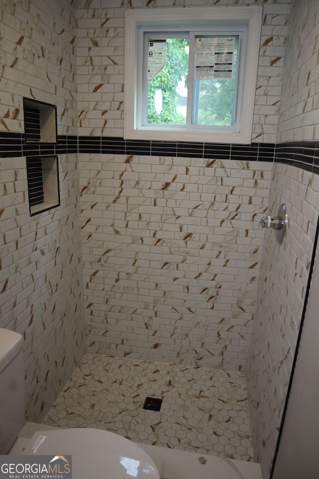 bathroom with toilet and a shower stall