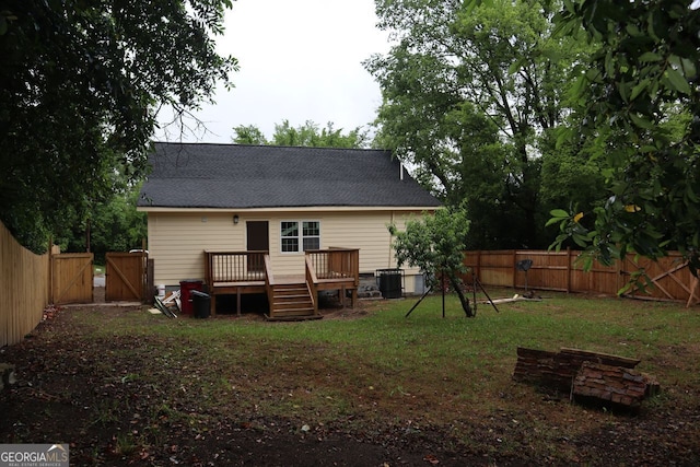 back of property featuring a gate, roof with shingles, a deck, and a fenced backyard