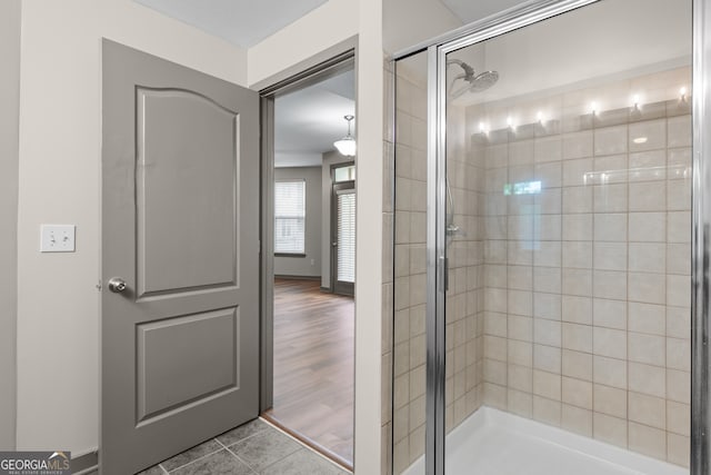 full bathroom featuring tile patterned flooring and a shower stall