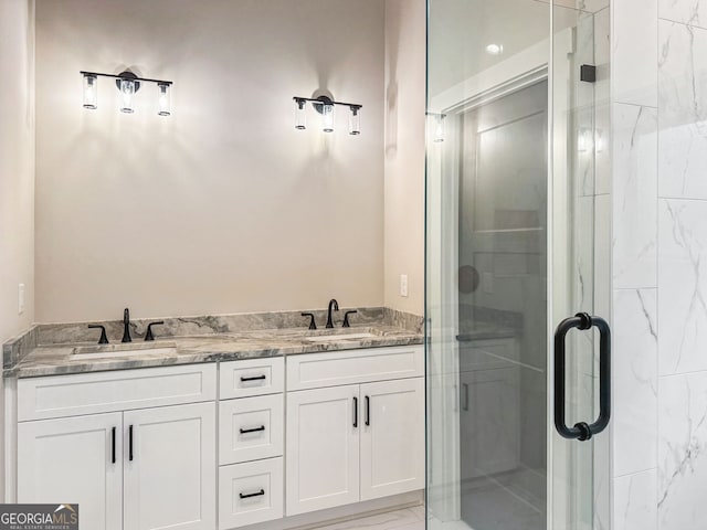 full bath featuring a sink, double vanity, and a shower stall