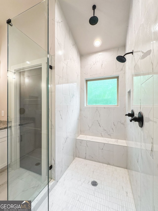 bathroom featuring a shower stall and marble finish floor