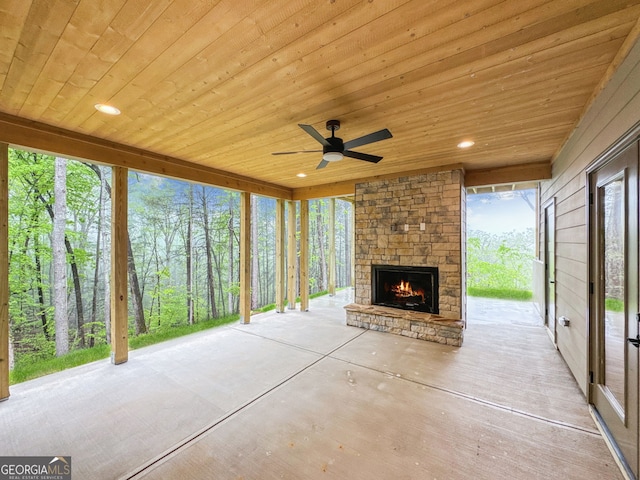 view of patio / terrace featuring an outdoor stone fireplace and a ceiling fan