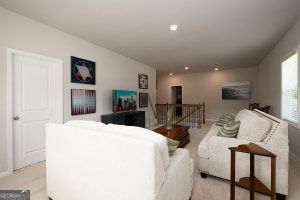 living area featuring light carpet, baseboards, and recessed lighting