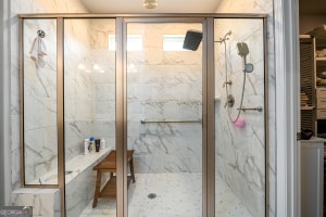 bathroom with a marble finish shower
