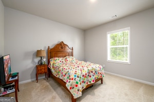 carpeted bedroom featuring baseboards