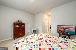 carpeted bedroom featuring baseboards and recessed lighting