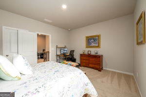bedroom featuring baseboards, recessed lighting, and light colored carpet