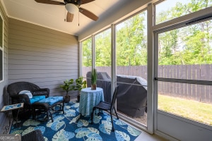 sunroom / solarium featuring a ceiling fan