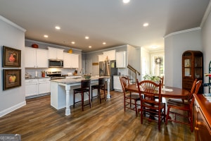 dining room featuring recessed lighting, crown molding, and dark wood-style floors