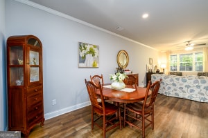 dining space with crown molding, wood finished floors, baseboards, and recessed lighting
