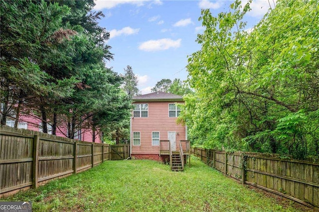 2171 Wilson Ave NW, Atlanta, GA 30314 - rear view of house featuring a fenced backyard and a lawn