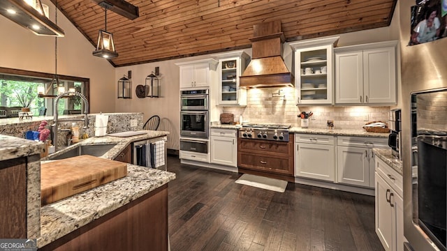 kitchen with wood ceiling, a sink, stainless steel appliances, a warming drawer, and custom exhaust hood