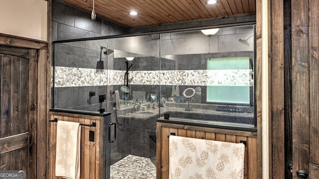 full bathroom with a shower stall, a sink, recessed lighting, and wood ceiling