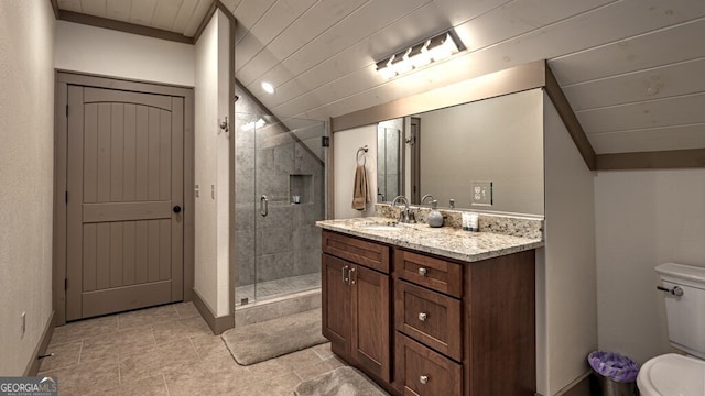 bathroom featuring toilet, wood ceiling, a stall shower, tile patterned flooring, and vanity