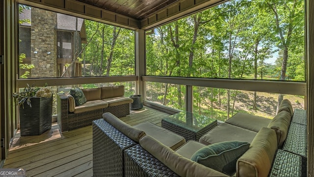 sunroom featuring a healthy amount of sunlight and outdoor lounge area