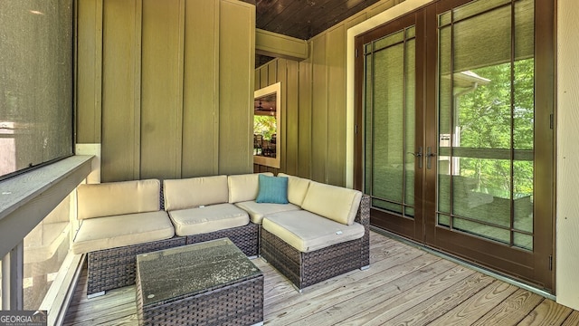 wooden deck featuring outdoor lounge area and french doors